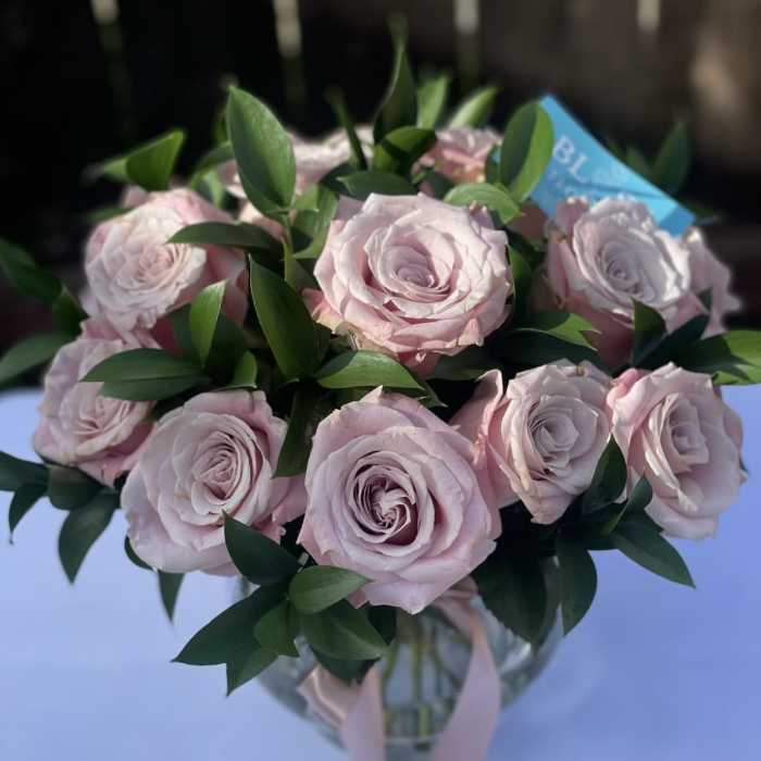 Bouquet of pale pink roses in a glass vase