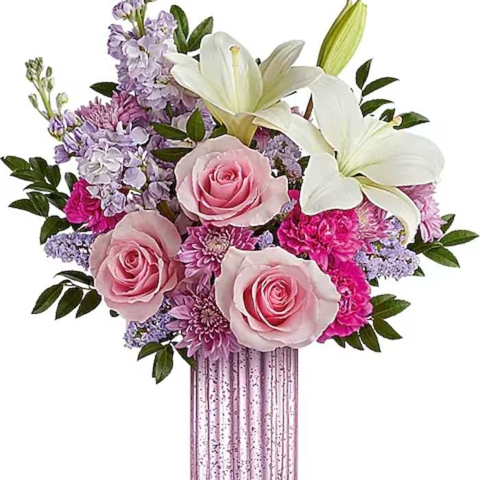 Pink roses and white lilies in a tall pink vase
