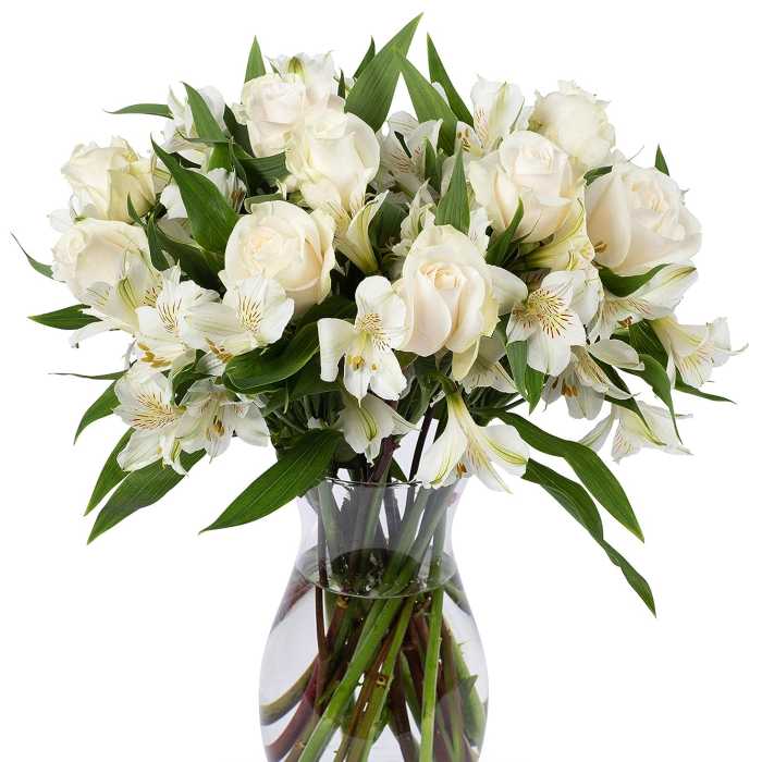 Arrangement of white roses and alstroemeria in a clear glass vase