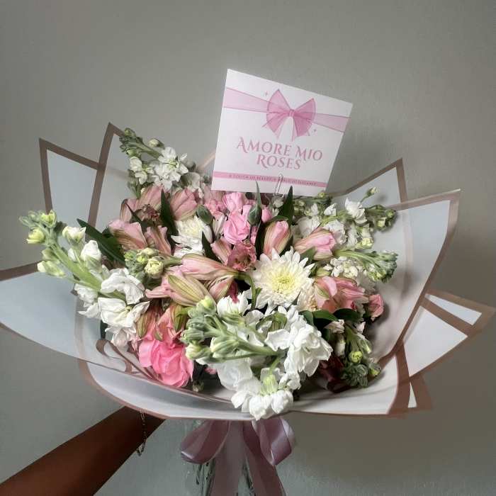 Pink and white bouquet with a ribbon and card