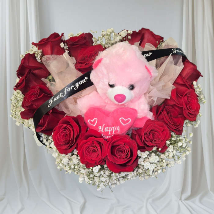 Red rose bouquet with a pink teddy bear and heart decoration