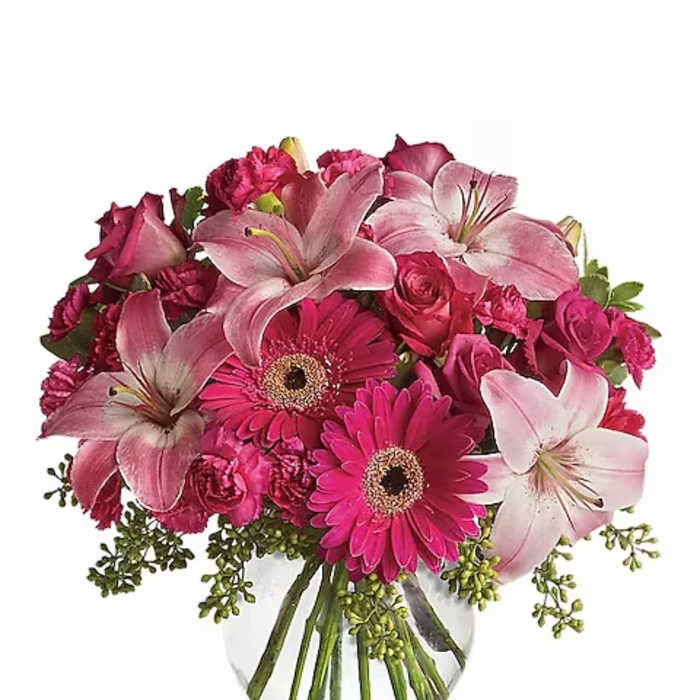 Pink bouquet with lilies, gerbera daisies, and roses in a glass vase