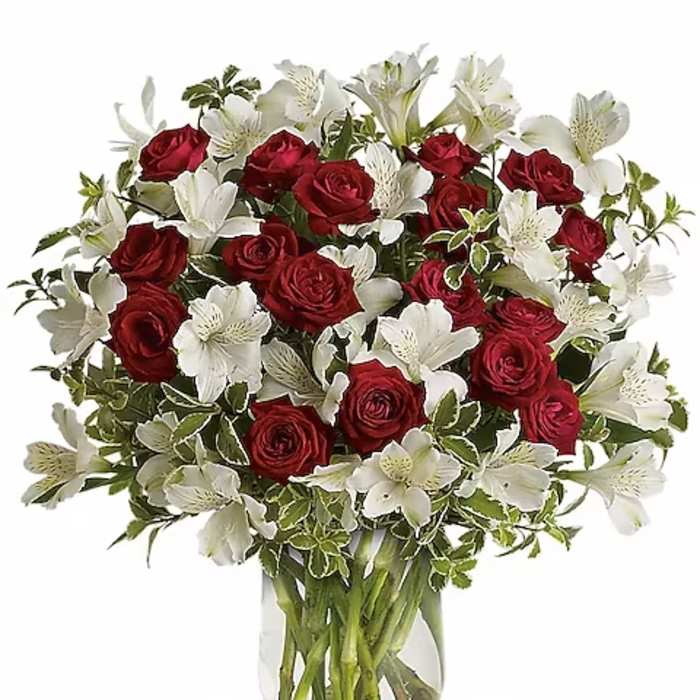 Red roses and white lilies in a clear glass vase