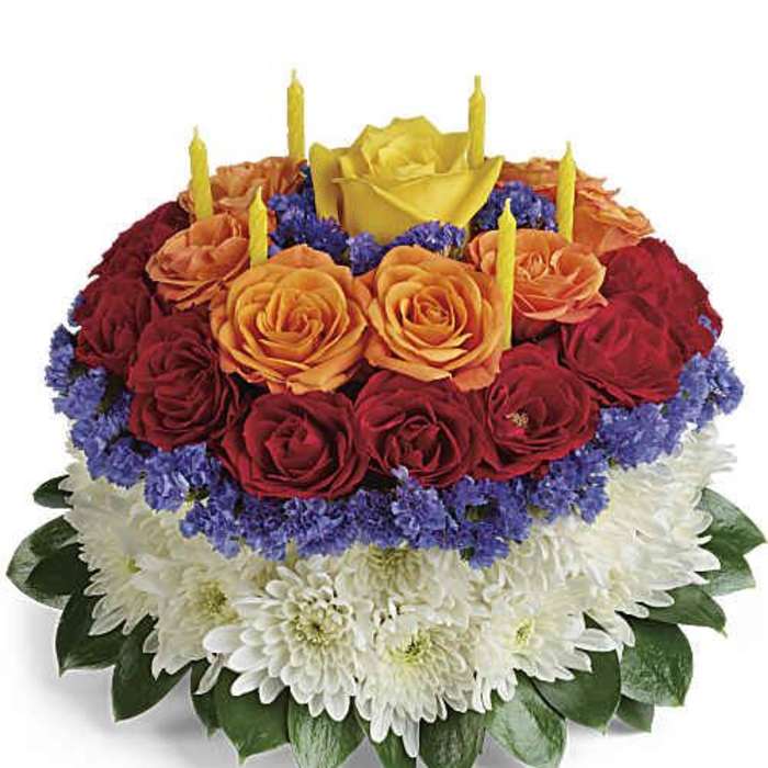 Round floral cake with roses and candles