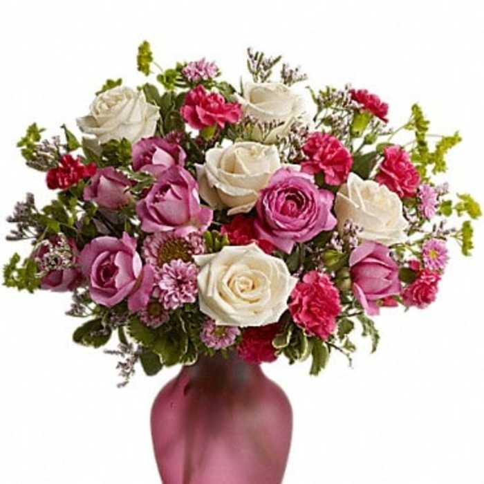 Pink and white rose bouquet in a pink vase
