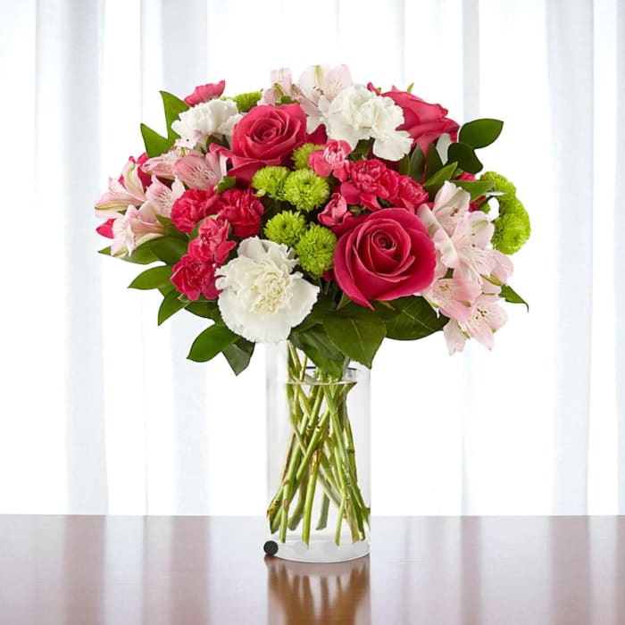 Pink and white mixed bouquet in a clear glass vase