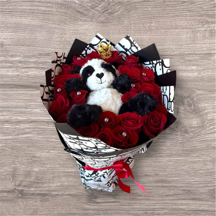 Bouquet of red roses with a teddy bear in the center