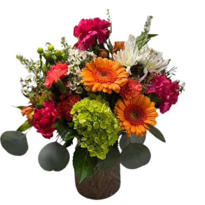 Mixed bouquet in a brown vase with orange gerberas and pink carnations