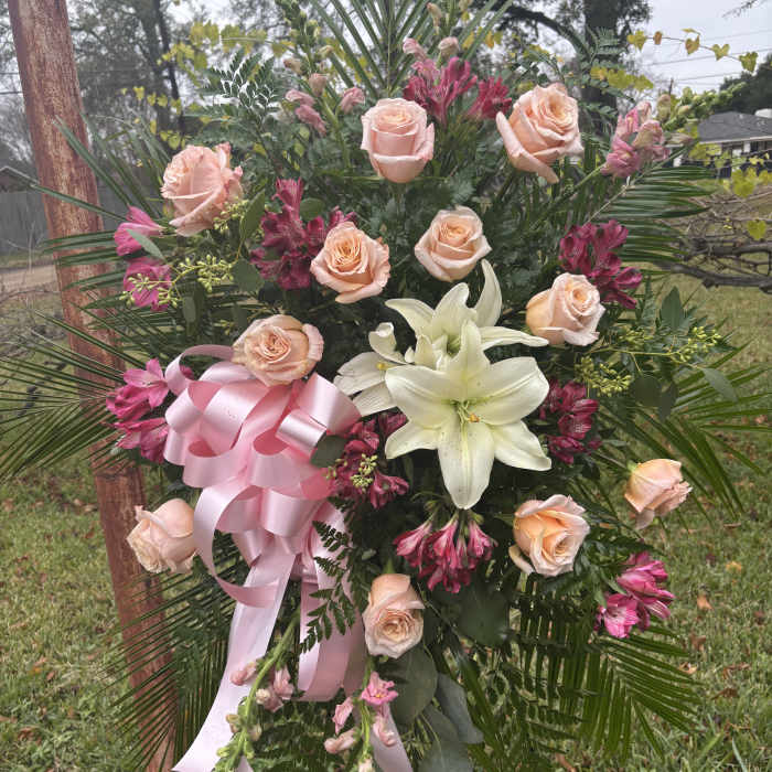 Pink rose and white lily standing spray with a pink ribbon