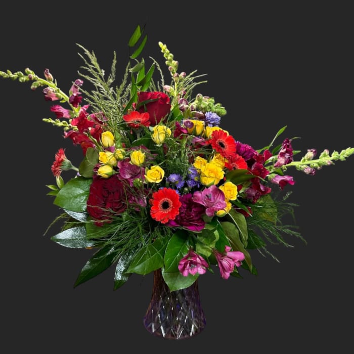Colorful mixed flower arrangement in a glass vase