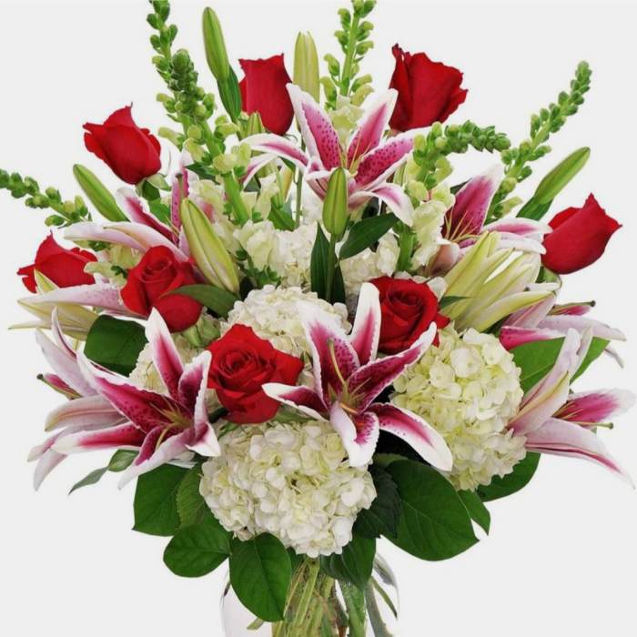 Bouquet of red roses, pink lilies, and white hydrangeas