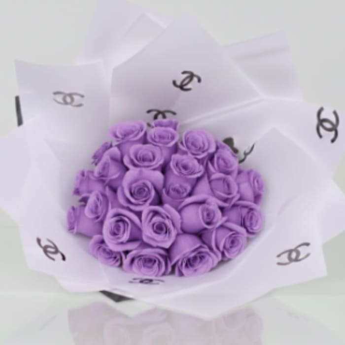 Bouquet of purple roses wrapped in white paper