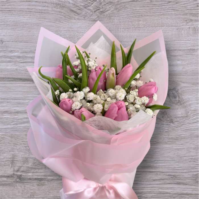Pink tulip bouquet with white baby's breath wrapped in pastel pink paper