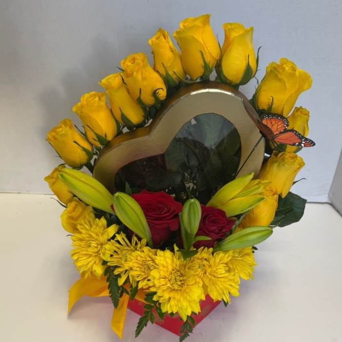 Heart-shaped floral arrangement with yellow roses, red roses, and yellow chrysanthemums