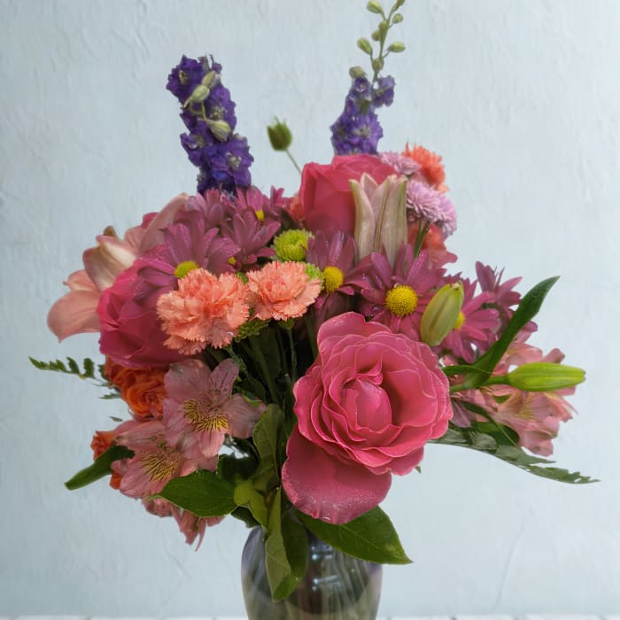 Pink and purple mixed bouquet in a glass vase