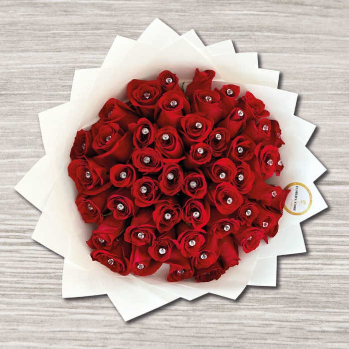 Bouquet of red roses wrapped in white paper