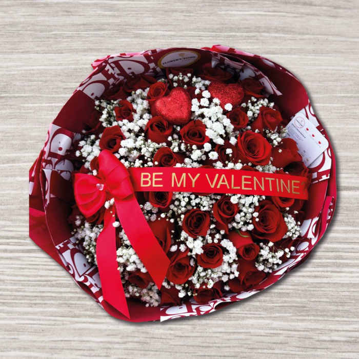 Bouquet of red roses with white baby's breath and a Valentine ribbon