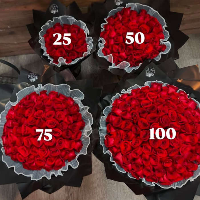 Four bouquets of red roses wrapped in black paper with white ruffles