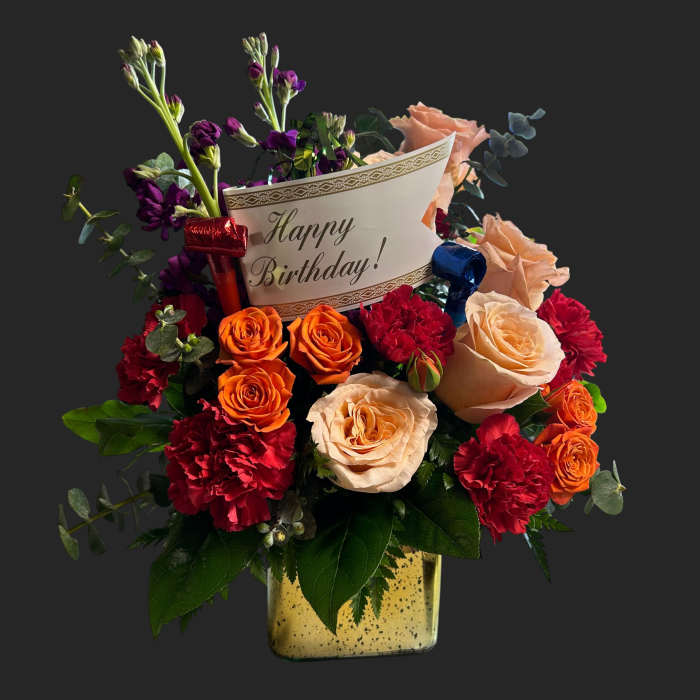 Mixed bouquet in a gold vase with a Happy Birthday card