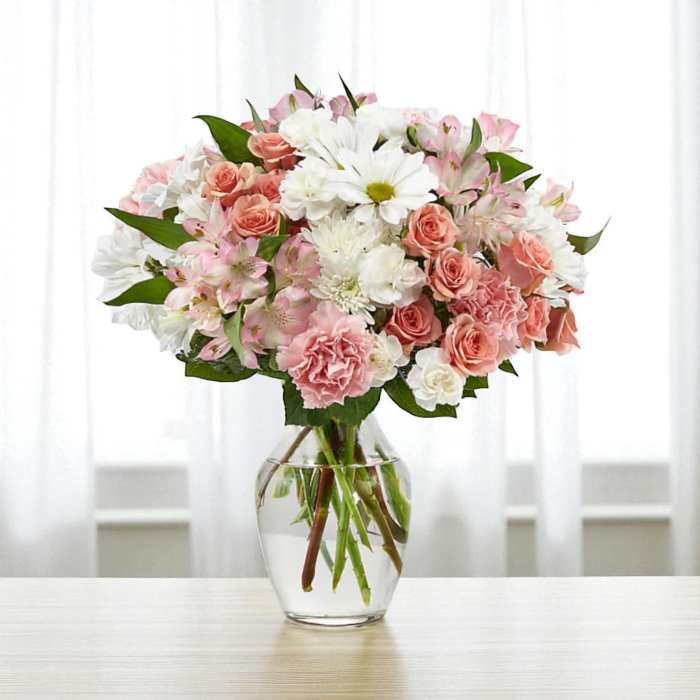 Pink and white mixed bouquet in a clear glass vase