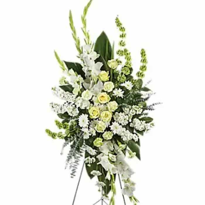 Standing floral spray of white and pale yellow flowers on an easel
