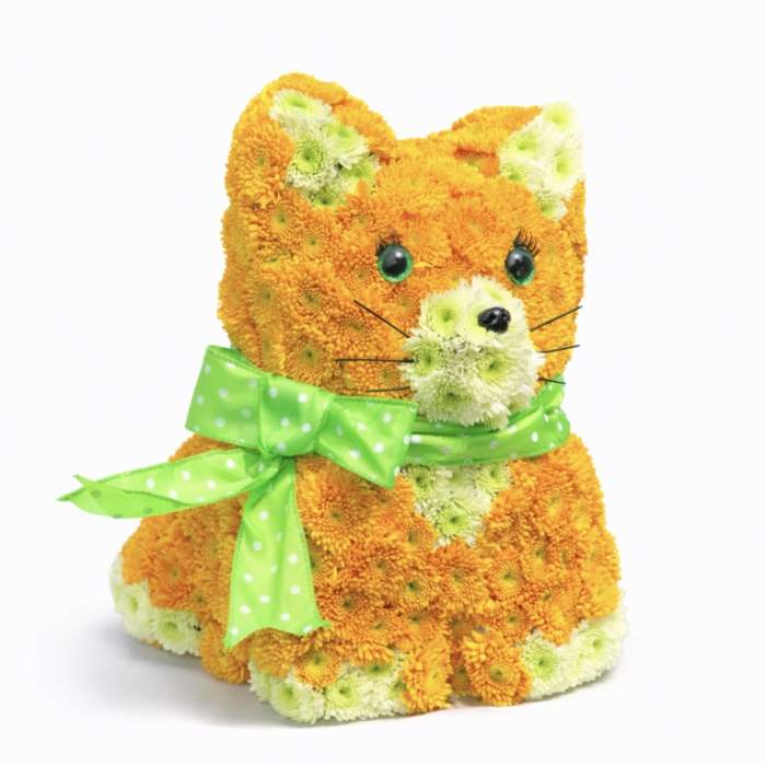 Flower-covered cat figurine with a green ribbon bow