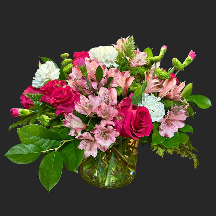 Pink roses and alstroemeria in a glass vase with white carnations