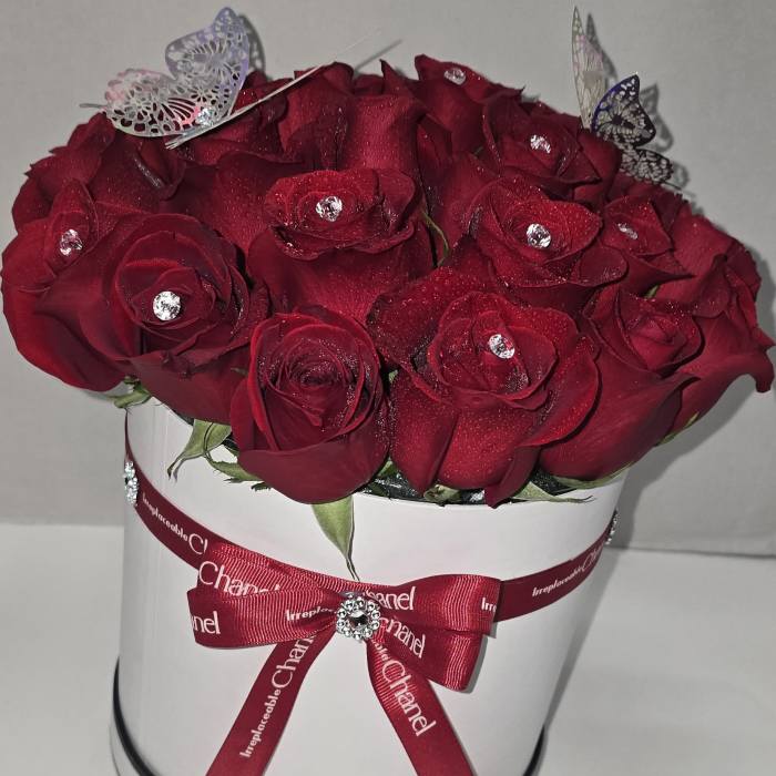 Red rose bouquet in a white hat box with a ribbon bow