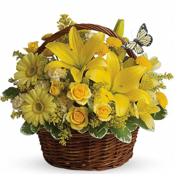 Yellow flowers arranged in a wicker basket with a butterfly decoration