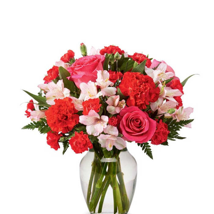 Pink and red flower bouquet in a clear glass vase