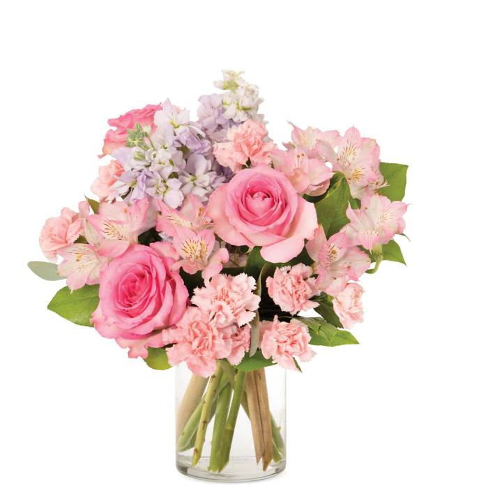 Pink rose, carnation, and alstroemeria bouquet with lavender stock in a clear glass vase