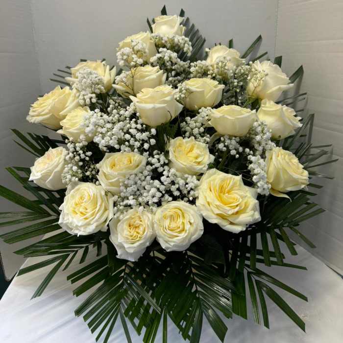 White rose bouquet with baby's breath and palm leaves