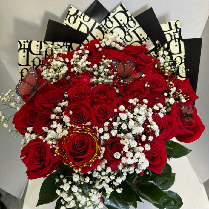 Bouquet of red roses with white baby's breath and butterfly accents