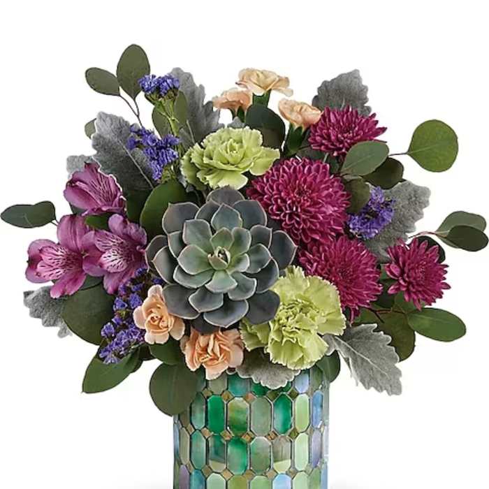 Mixed bouquet in a mosaic glass vase with a central succulent