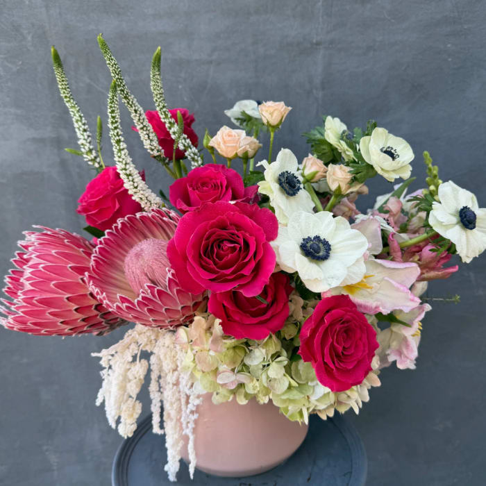 Pink roses and white anemones in a blush vase