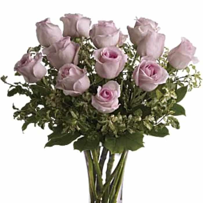 Bouquet of pale pink roses in a clear glass vase