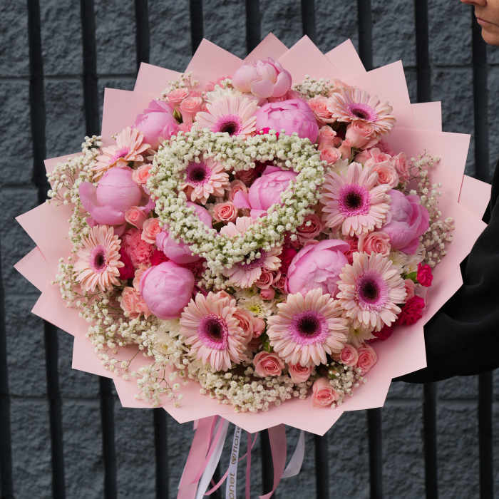Large pink bouquet with gerbera daisies and roses wrapped in pink paper