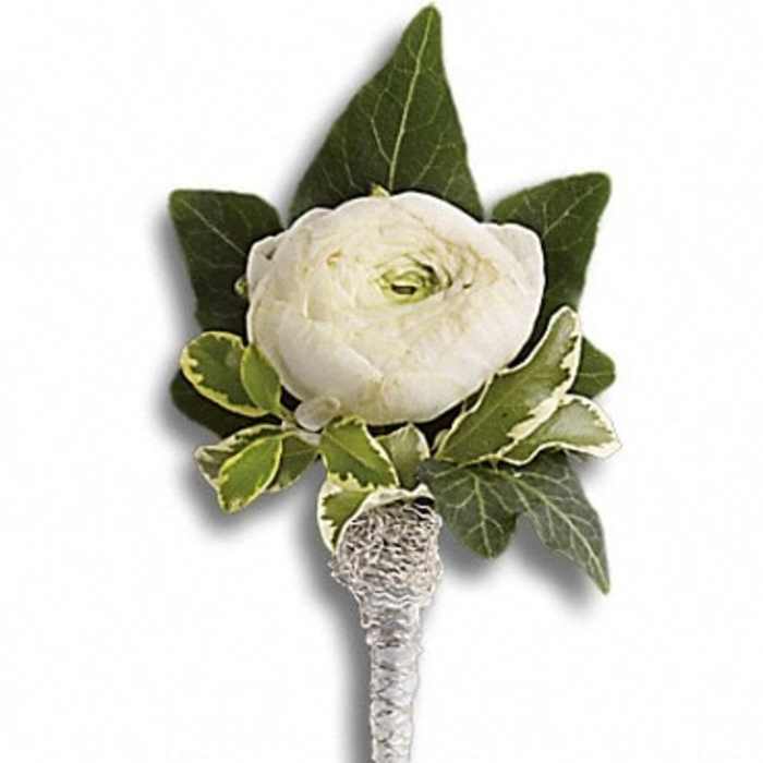 White rose boutonniere with green leaves and a wrapped stem