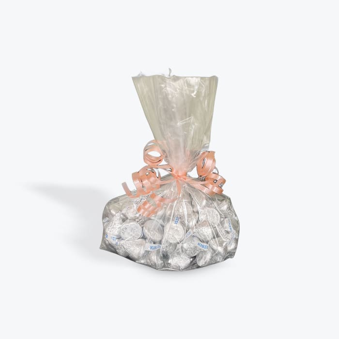Bag of silver-wrapped chocolates tied with a peach ribbon