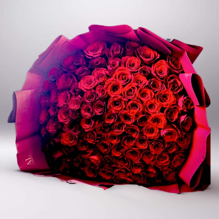 Large bouquet of red roses wrapped in pink paper