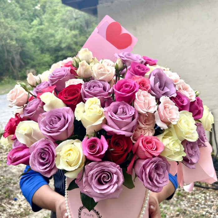 Pink hatbox arrangement of roses with a heart card