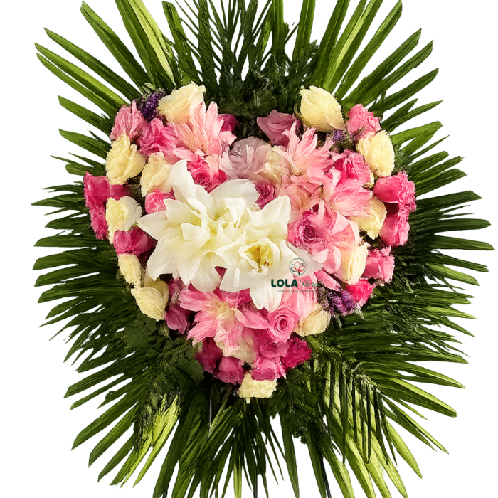 Heart-shaped pink and white flower standing spray with green foliage on a metal easel.