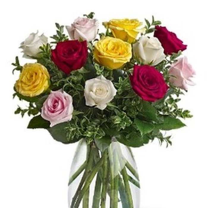 Bouquet of multicolored roses in a clear glass vase