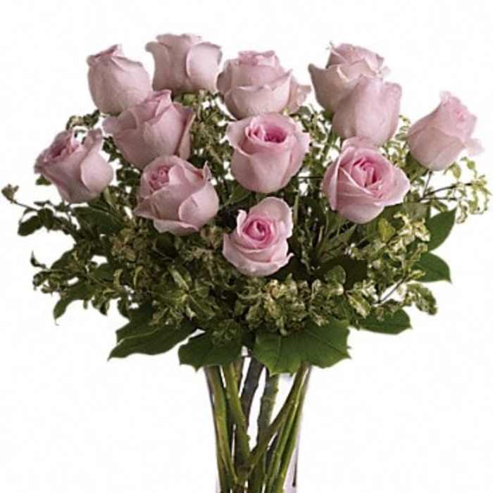Bouquet of pale pink roses in a clear glass vase