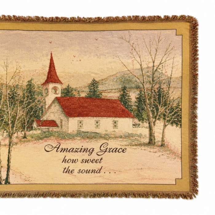Fringed wall hanging with a church scene and the words Amazing Grace