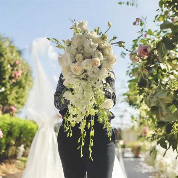 White bridal bouquet with cascading flowers and roses