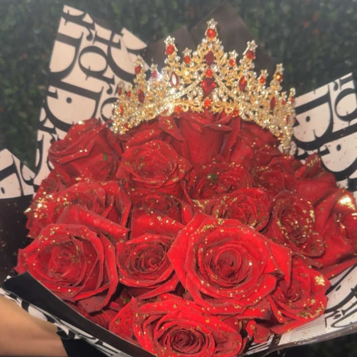 Bouquet of red roses with a jeweled crown and black-and-white wrapping