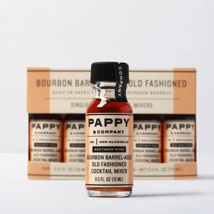 Bottle of non-alcoholic old fashioned cocktail mixer in front of a boxed set