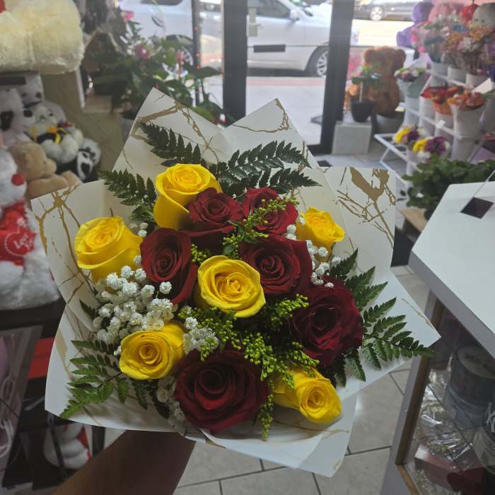 A dozen yellow and red roses