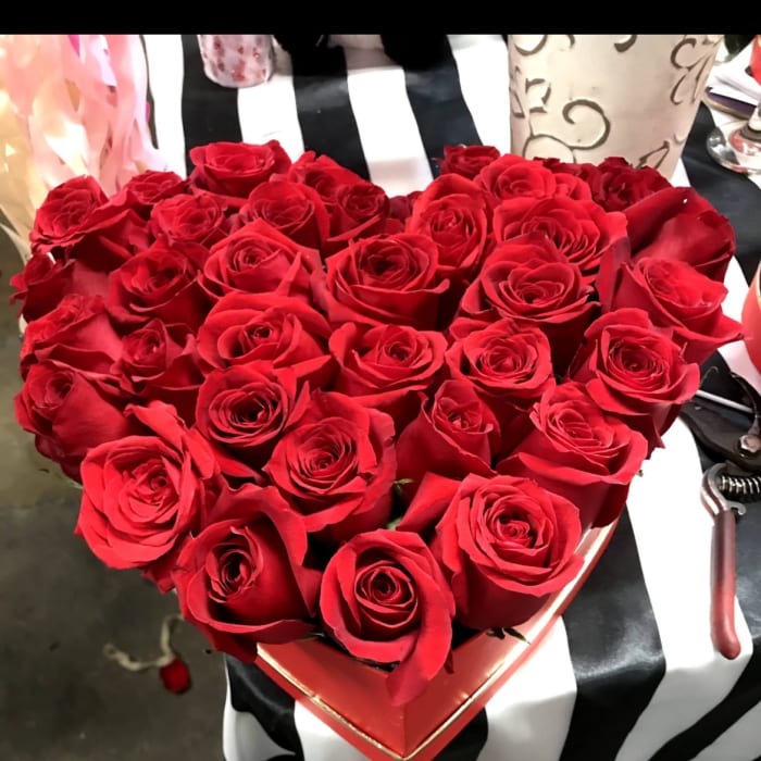 Heart-shaped box filled with red roses